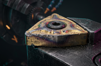 Fotografia macro mostrando uma pastilha de metal duro usada com sinais evidentes de desgaste de flanco e craterização.